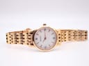 Horizontal full view of the Bulova 97P106 watch and its rose gold tone integrated steel bracelet on a display stand.