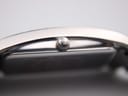 Extreme close-up of the watch's original crown, featuring the distinct Skagen logo engraving.