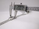 Digital caliper measuring the case width of the Skagen watch, displaying a precise measurement of 20.07mm.