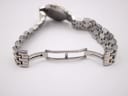 Detailed view of the watch's two-tone stainless steel deployant clasp, showing its construction.