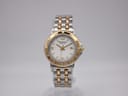 Front view of Raymond Weil Tango two-tone ladies watch with white dial and gold-plated bezel.