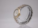 Side view of the Raymond Weil Tango watch, showing the gold crown and two-tone bracelet.