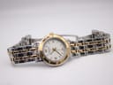 Top-down angled view of the Raymond Weil Tango watch, with the two-tone bracelet laid flat.