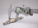 Digital caliper measuring the watch case diameter at 28.02mm.