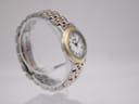 Opposite angled side view of the Raymond Weil watch, highlighting the gold-tone bezel and bracelet links.
