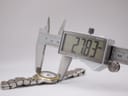 Digital caliper measuring the watch case diameter at 27.83mm, excluding the crown.
