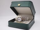 The Raymond Weil Genève 5360 watch presented inside an open dark green box.