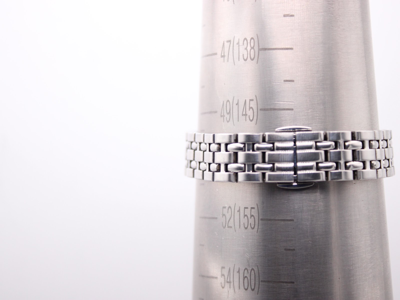 Watch bracelet displayed on a metal wrist sizing cone, indicating a current fit size of approximately 150mm (50 units).