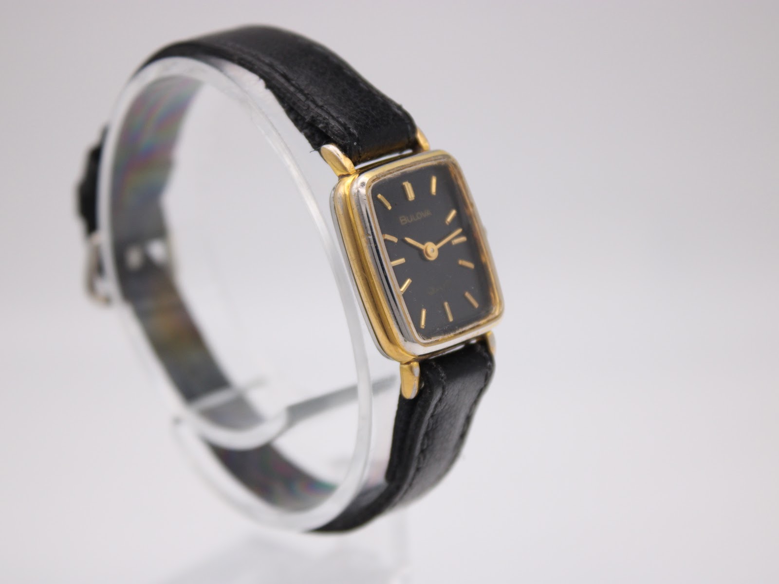Another angled side view of the Bulova SL200 watch, showing the contrast between the gold tone bezel and the stainless steel back.