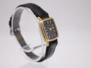 Another angled side view of the Bulova SL200 watch, showing the contrast between the gold tone bezel and the stainless steel back.