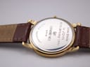 Close-up of the watch case back showing "Love Sheila to John 60th. Birthday 1994" engraving and "Water Resistant Raymond Weil 5548".