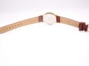 Rear view of the watch and strap laid flat, showing "Genuine Leather" and "18" mark on the strap.