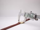 Digital caliper measuring the watch case diameter, displaying 34.51mm.