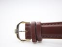Close-up of the gold tone buckle, clearly showing the engraved "RW" logo.
