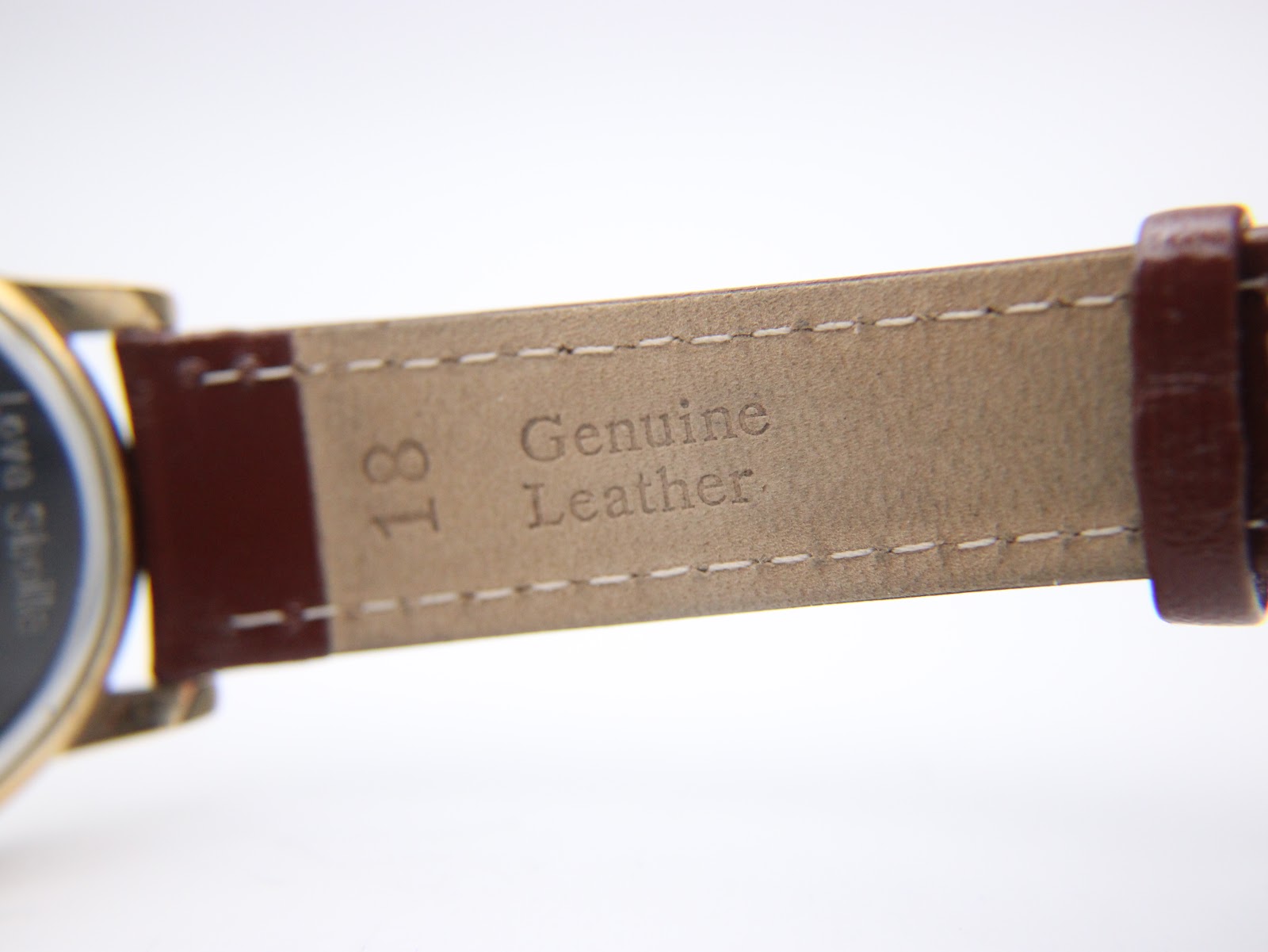 Close-up of the underside of the strap, showing "Genuine Leather" and "18" lug width marking.