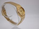 Side-angled view of the gold Tissot Stylist, highlighting the textured case and bracelet.