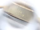 Macro shot of a subtle marking or engraving on the side of the watch case.