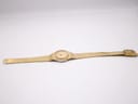 Full length view of the Tissot Stylist watch and integrated bracelet, laid flat on a white background.