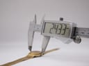Digital caliper measuring the case diameter of the Tissot Stylist at 24.33mm.