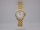 Front view of gold Raymond Weil Genève 5368 watch with white dial and Roman numerals on a clear stand.