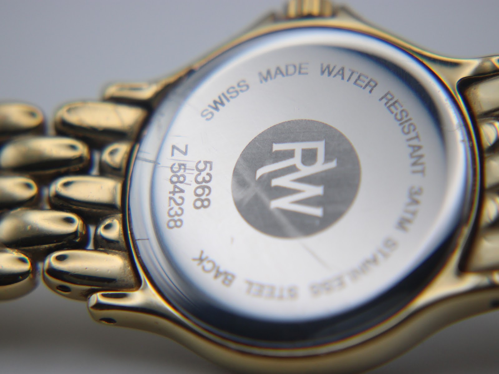 Close-up of the stainless steel case back with engravings 'Swiss Made Water Resistant 3ATM Stainless Steel Back 5368 Z584238' and the RW logo.