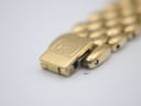 Close-up of the gold-plated bracelet's fold-over clasp, showing the embossed 'RW' logo.