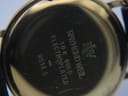 Close-up of the watch's gold case back, showing engravings for 'Raymond Weil', '18K GOLD ELECTROPLATED', and '9514.5'.