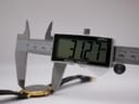 Digital caliper measuring the watch case, with the display clearly showing '31.27 mm'.