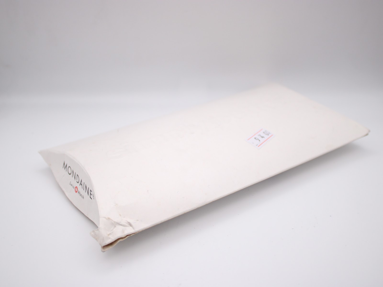 Back of the Mondaine paper sleeve packaging with a price sticker.