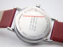Close-up of the stainless steel case back of the Mondaine watch, showing engraved text including "Official Swiss Railways Watch", "SBB CFF FFS", "Stainless Steel Case", "30323", and "Water Resistant".