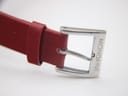 Close-up of the silver-tone buckle on the red leather strap, clearly showing the 'MONDAINE' engraving.