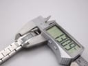 Digital caliper measuring the case width of the Gucci 4600L, displaying an exact measurement of 13.09 mm.