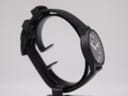 Top-down view of the Mondaine watch with its black rubber strap extended, showcasing the full length