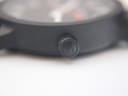 Close-up of the textured rubber strap, showing the repeated 'M' logo pattern near the case back