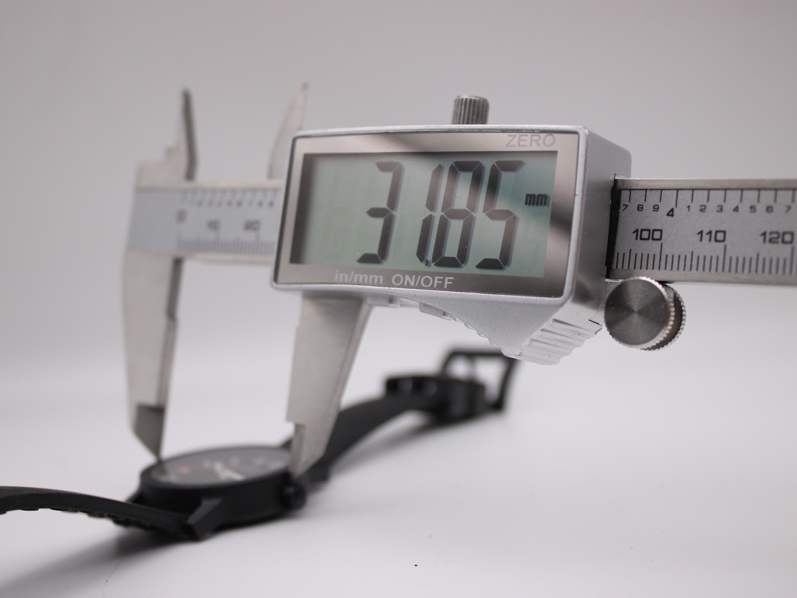 Digital caliper measuring the case diameter of the Mondaine watch, displaying 31.85mm precisely