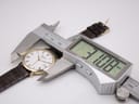 Close-up of the Raymond Weil watch being measured by a digital caliper, showing a case diameter of 31.08mm.