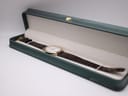The Raymond Weil Geneve watch presented inside a dark green, white-lined watch gift box.