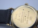 Close-up of the watch case back, revealing engravings: 'RAYMOND WEIL GENEVE', '18K GOLD ELECTROPLATED', 'WATER RESISTANT 10 M', and '9923'.