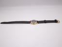 Side view of the Raymond Weil watch with its dark brown leather strap laid flat against a white background, showcasing its full length.