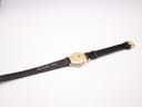 Back view of the watch and strap, showing the underside of the strap with 'REAL LEATHER' text and the case back.
