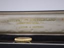 Close-up of the 'Watches of Switzerland 16 New Bond Street' gold lettering inside the vintage watch box.