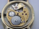 Macro shot of the manual wind watch movement, showing gears and 'R. WEIL SEVENTEEN 17 JEWELS SWISS' engraving.