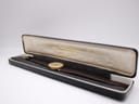 The Raymond Weil watch resting inside a vintage 'Watches of Switzerland' presentation box.