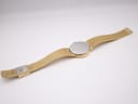 Back view of the Accurist watch showing the stainless steel case back and gold mesh bracelet.