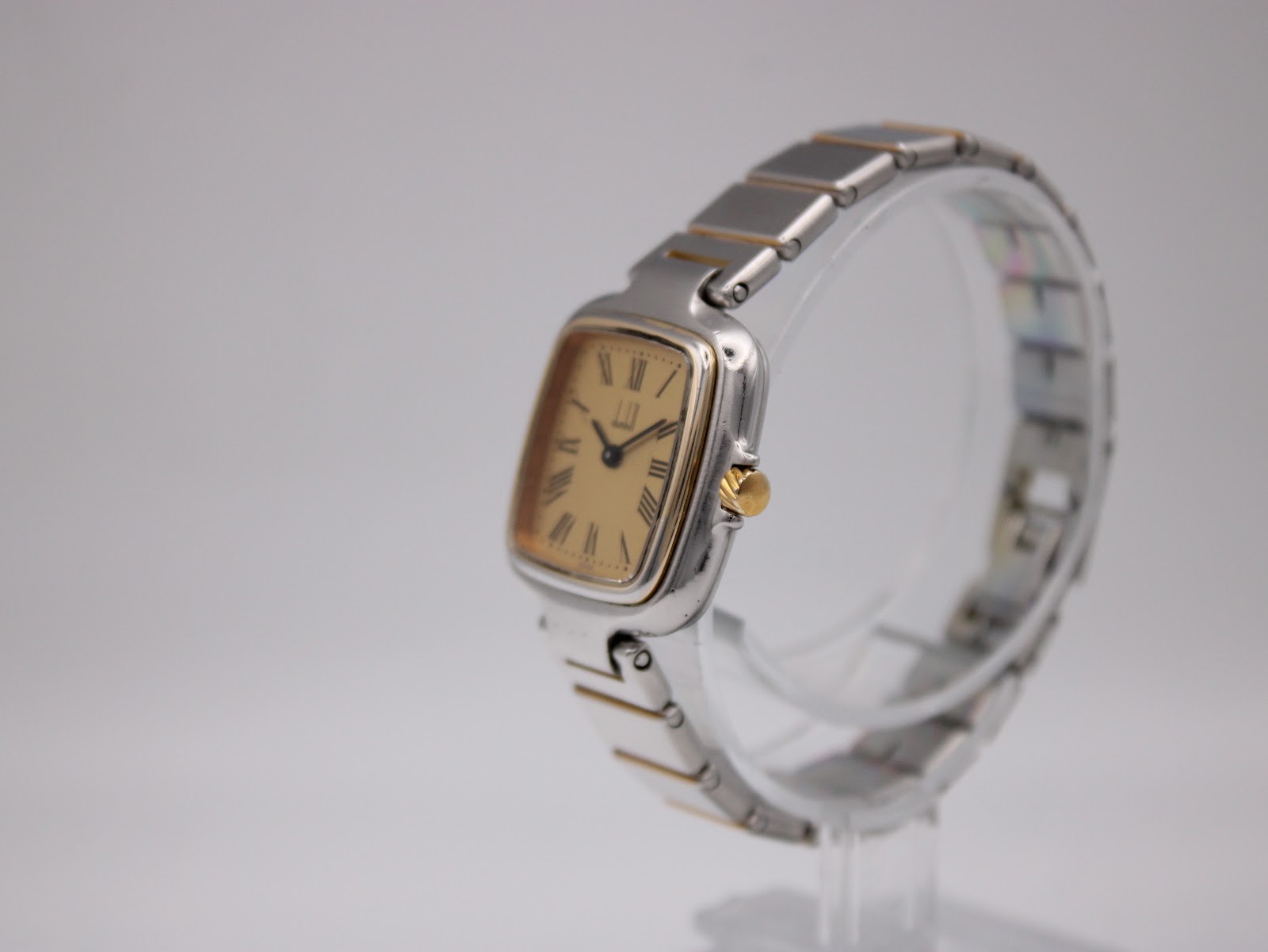 Angled view of the Dunhill Millennium watch, showing the two-tone case and integrated bracelet.