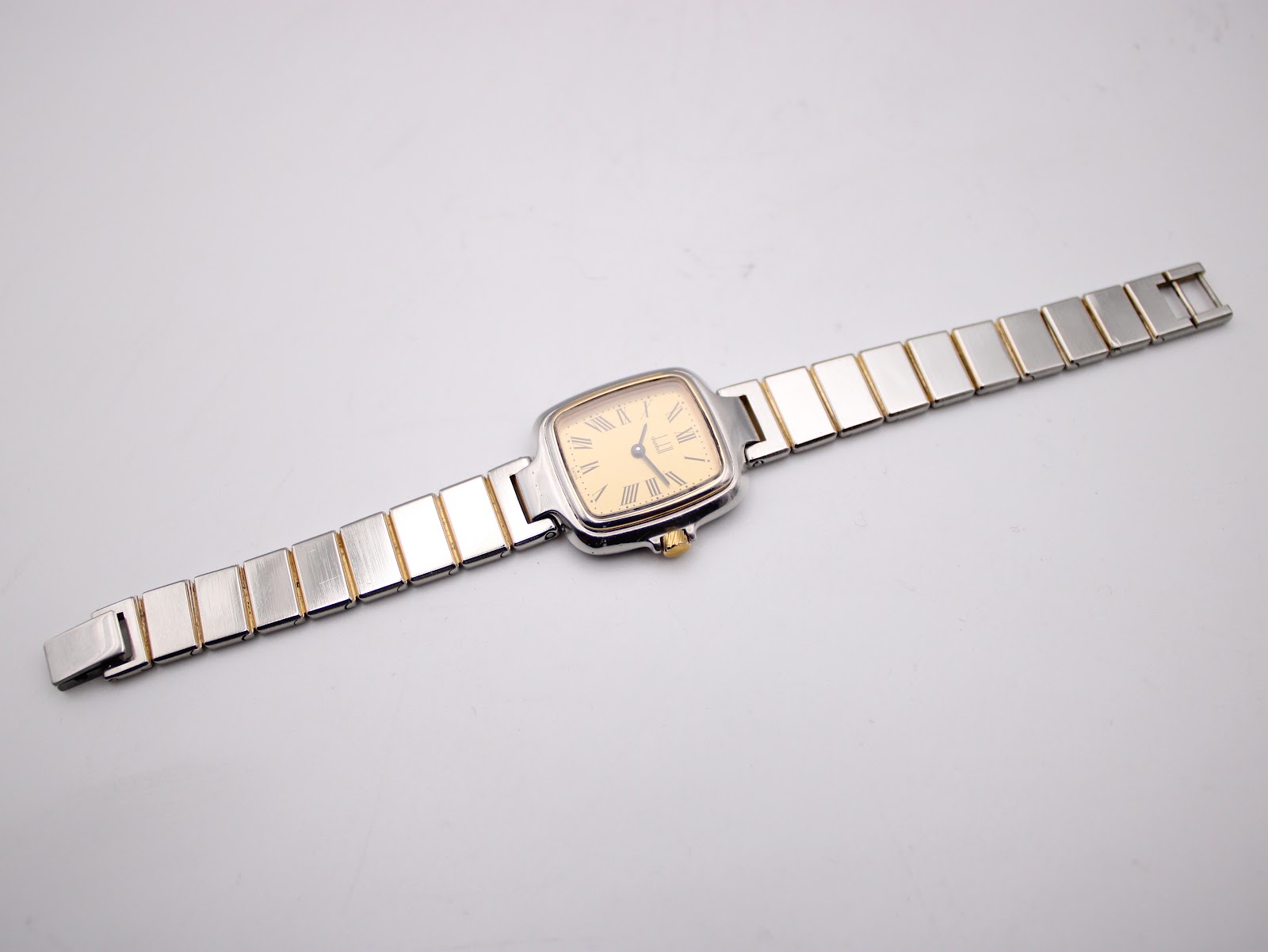 Top-down view of the Dunhill Millennium watch with its two-tone bracelet extended.
