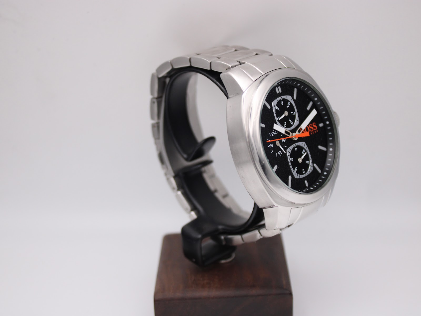 Left-side view of the Hugo Boss Orange watch on a stand, highlighting the robust stainless steel case and bracelet design.