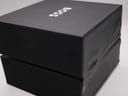 Top-down view of the black Hugo Boss presentation box with "BOSS" logo, showing some wear on the box exterior.