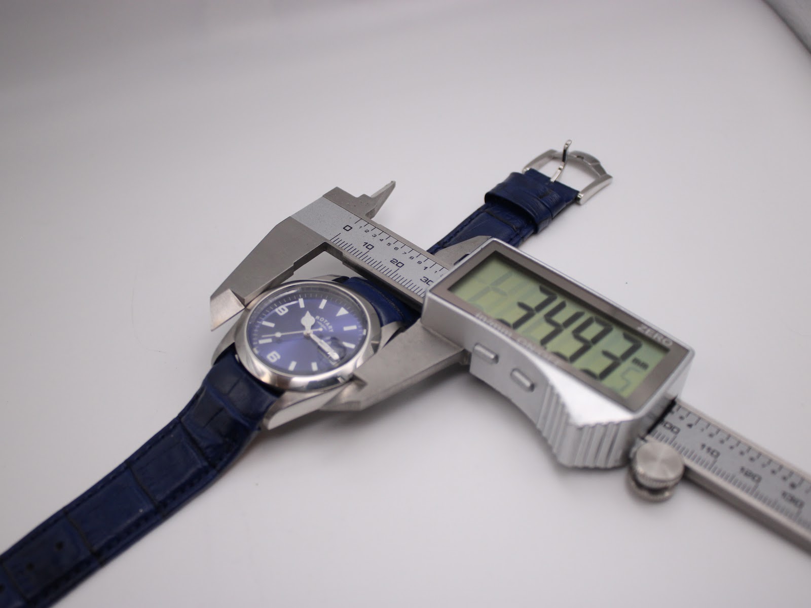 Digital caliper measuring the Rotary watch case diameter, displaying 34.93mm.