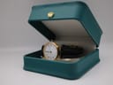 The Sewills watch positioned inside an open teal presentation box with a small gold crown emblem.